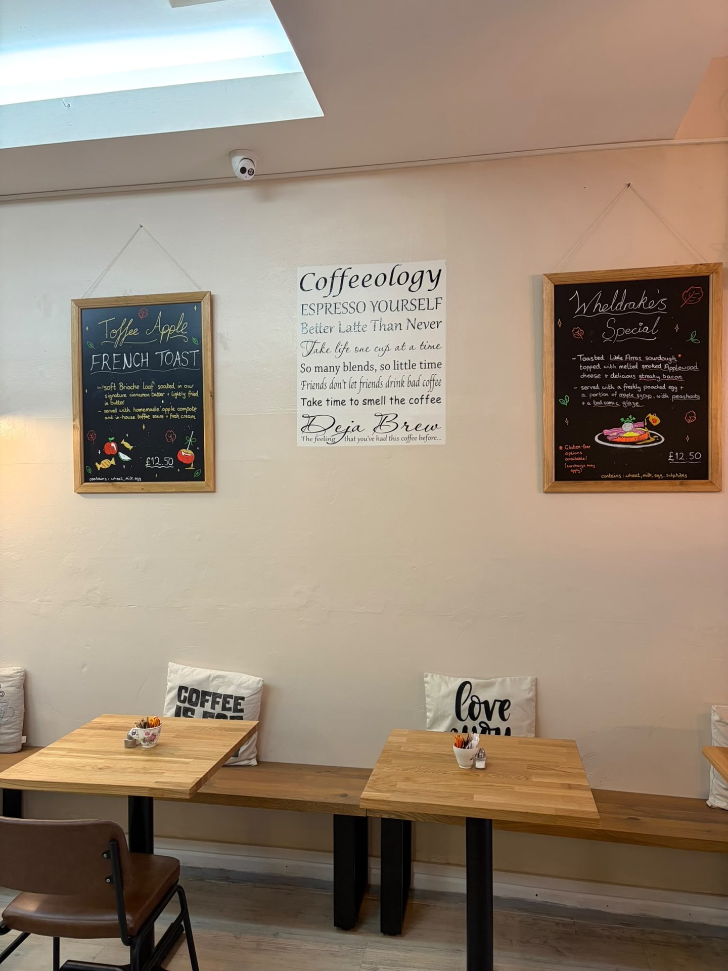 Handwritten French toast and Wheldrakes specials boards above the new wooden tables